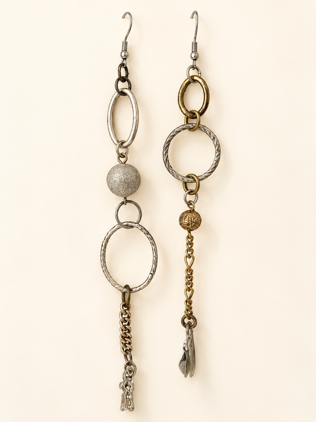 Mismatched long earrings with mixed metal rings, textured beads, vintage chains and dangling Kuchi charms.