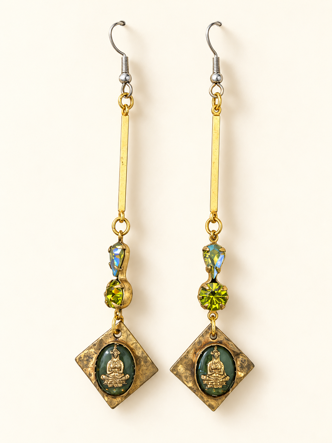 Long brass earrings with green Swarovski crystals and diamond-shaped pendants featuring green glass dancer intaglios.