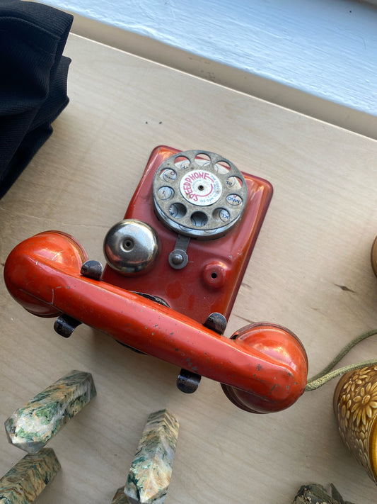 Vintage toy orange rotary phone